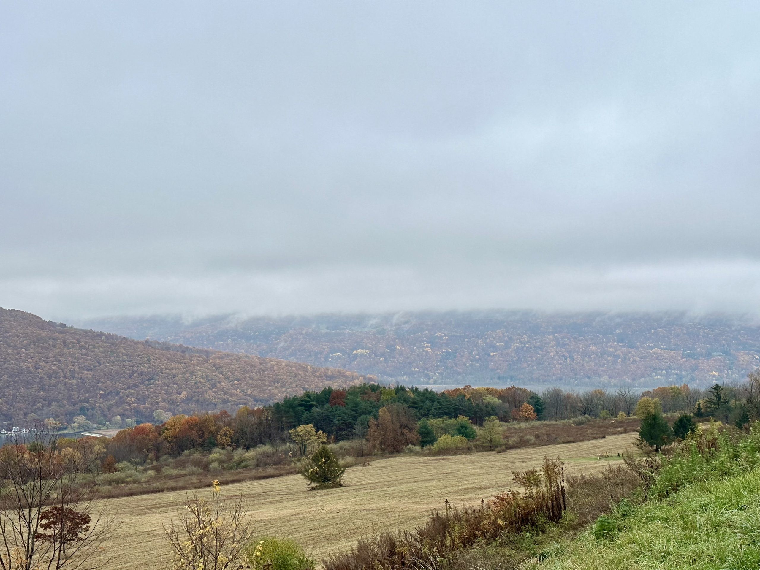 Autumn hills and open fields beneath low clouds